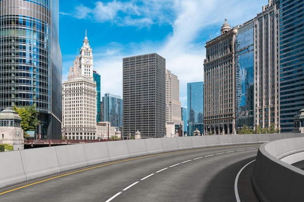 Empty urban asphalt road exterior with city buildings background New modern highway concrete construction Concept of way to success Transportation logistic industry fast delivery Chicago USA