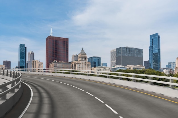 Empty urban asphalt road exterior with city buildings background New modern highway concrete construction Concept of way to success Transportation logistic industry fast delivery Chicago USA