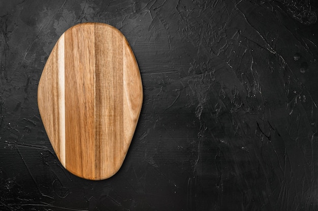 Empty vintage cutting board set, on black dark stone table background, top view flat lay , with copy space for text or your product