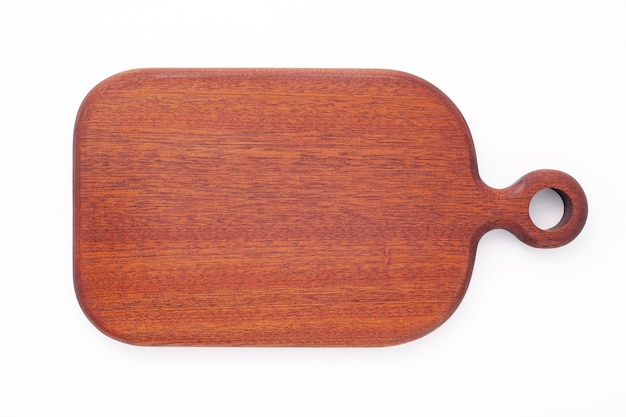 Empty vintage wooden cutting board isolated on white background top view.