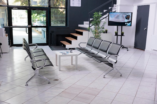 Empty waiting room in healthcare clinic lobby, space used to wait before attending checkup appointments and consultations. Interior of medical facility with chairs, hospital examinations.