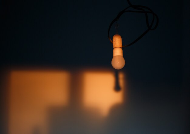 Empty wall of the room lit by orange sunset light. Abstract background.