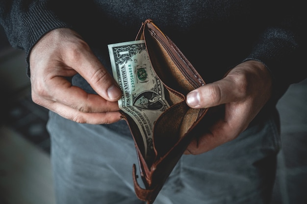 Empty wallet in the hands of a young man