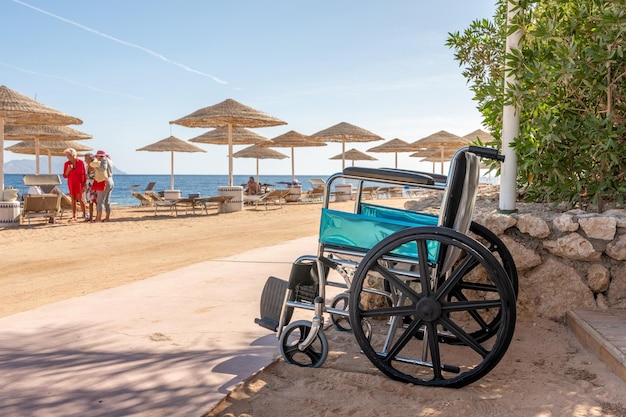 Empty wheelchair against the background of tropical beach