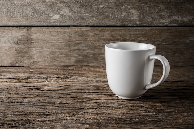 empty white cup on wooden table background