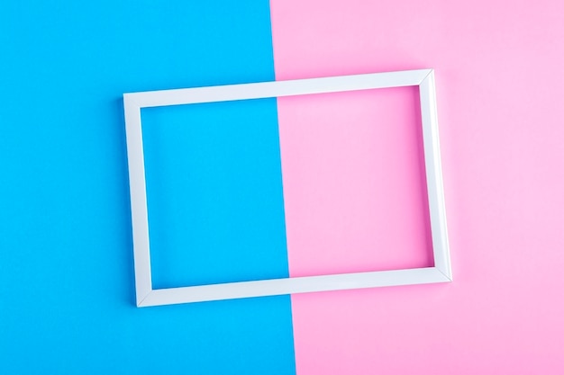 Empty white frame on a duotone background (blue, pink) with copy space for text or lettering. Minimal geometric lines composition. Top view, flat lay, mock up.