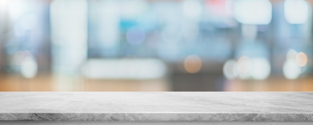 Empty white marble stone table top and blur glass window interior cafe and restaurant banner mock up abstract background - can used for display or montage your products.