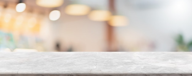 Empty white marble stone table top and blur glass window interior cafe and restaurant