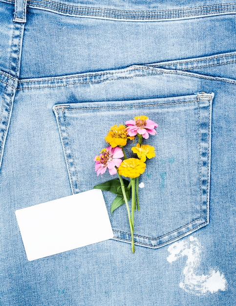 Empty white paper card and a bouquet of flowers