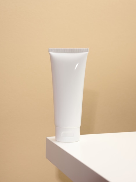 Empty white plastic tubes for cosmetics on a white table. Packaging for cream, gel, serum, advertising and product promotion, mock up