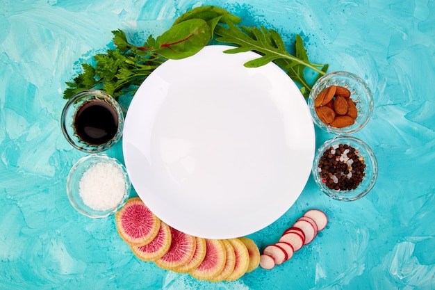 Empty white plate. Ingredient and salad