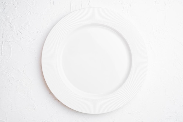 Empty white plate porcelain with copy space for text or food with copy space for text or food top view flat lay on white stone table background