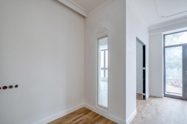 Empty white room with repair and without furniture with panoramic windows