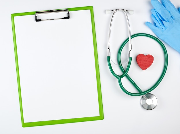 Empty white sheets and medical stethoscope on white