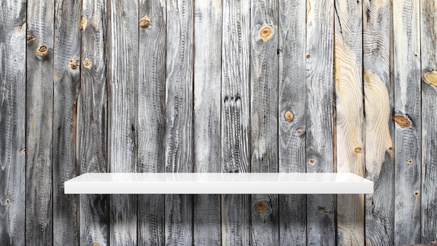 Empty white wall shelf on old planked wall