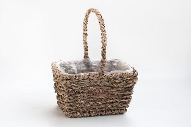 Empty wicker basket made of vines on a white background Easter Item