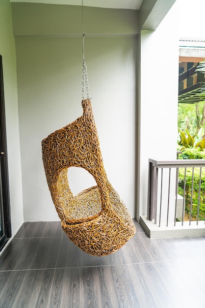 Empty wicker swing on blacony