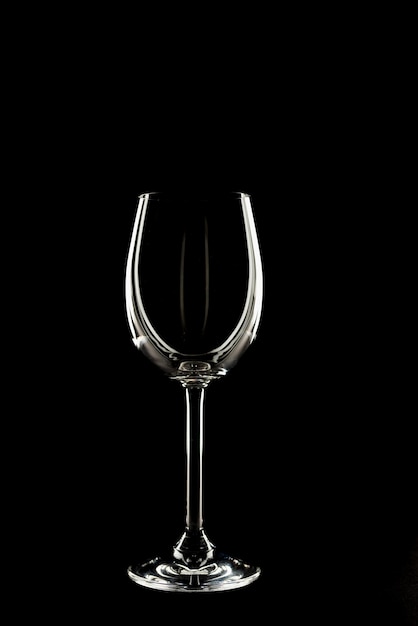 Empty wine glass on black background