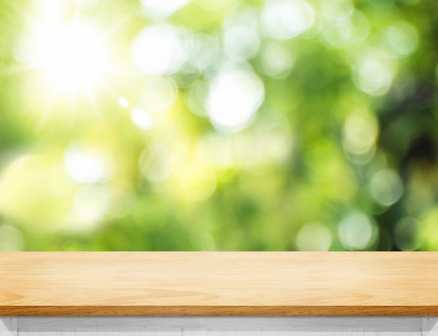 Empty wood plank table top with blur tree in park