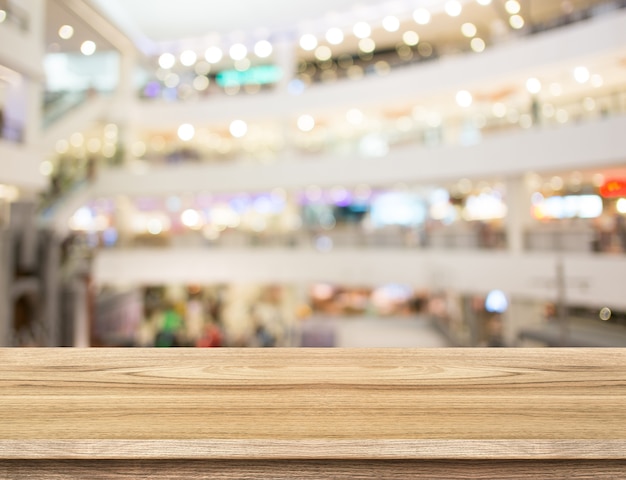 Photo empty wood table and blurred department store background. product display template