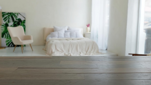 Empty wood table overlooking a white bedroom chair bed and windows relaxing bright mock up