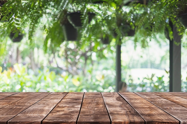 Empty wood table top and blurred green tree and fruit vegetable in agricultural farms background - can used for display or montage your products.