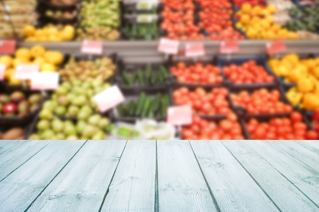 Empty wood table top on blurred market fruit,shop. 