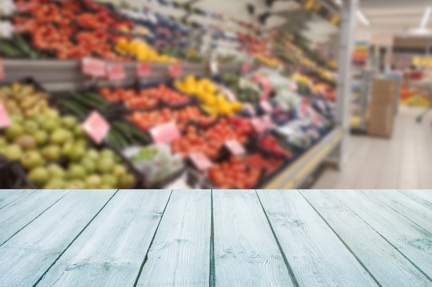 Empty wood table top on blurred market fruit,shop. 