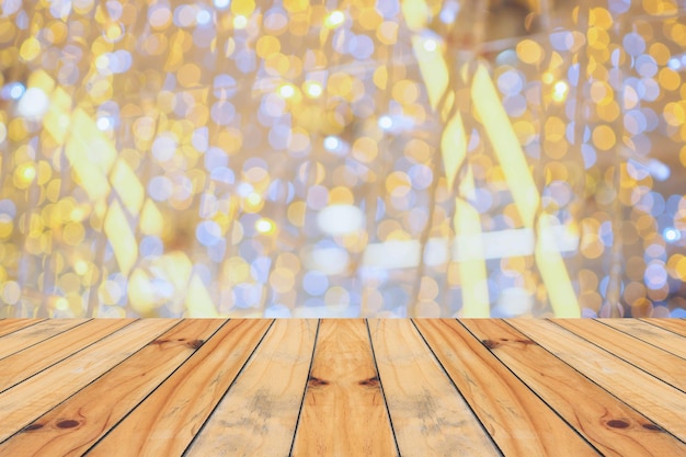 Empty wood table top with blur Christmas tree with bokeh light background