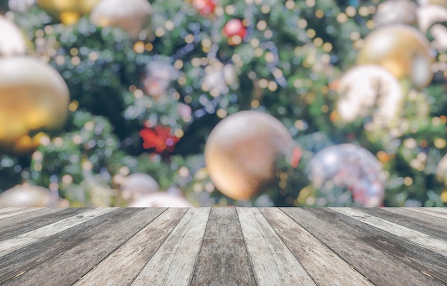 Empty wood table top with blur Christmas tree with bokeh light background