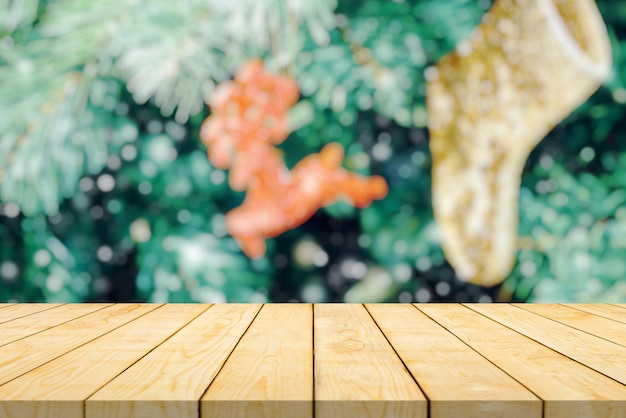 Empty wood table top with blur Christmas tree with bokeh light background