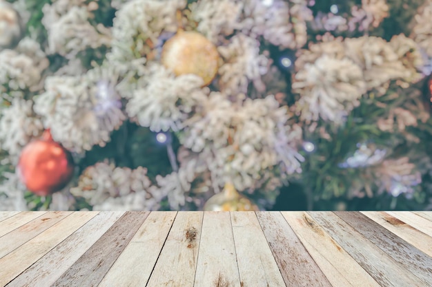 Empty wood table top with blur Christmas tree with bokeh light background