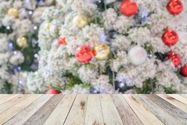 Empty wood table top with blur Christmas tree with bokeh light background