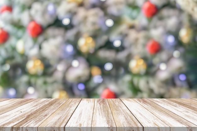 Empty wood table top with blur Christmas tree with bokeh light background