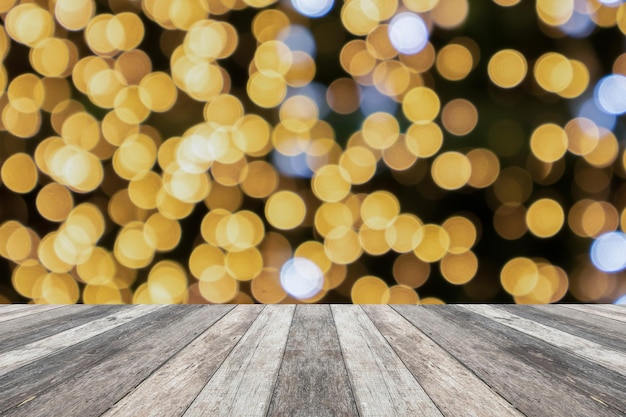 Empty wood table top with blur Christmas tree with bokeh light background