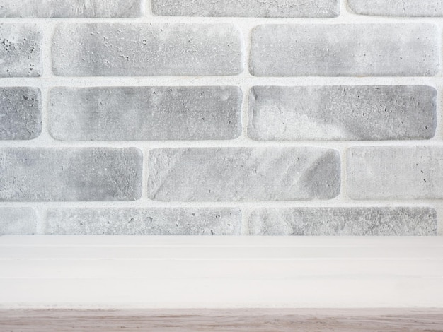 Empty wood table top with gray brick background