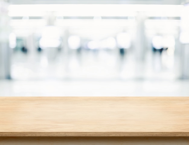 Photo empty wood table top with office building hall way blur background