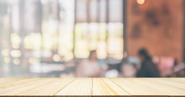 Empty Wood table top with Restaurant cafe coffee shop interior blur background