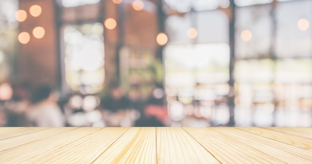 Empty Wood table top with Restaurant cafe or coffee shop interior with customer