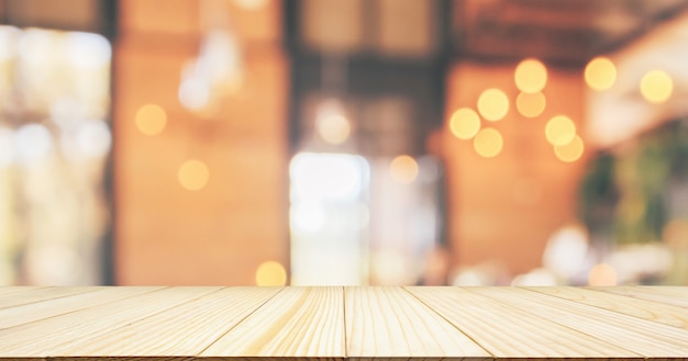 Empty Wood table top with Restaurant cafe or coffee shop interior