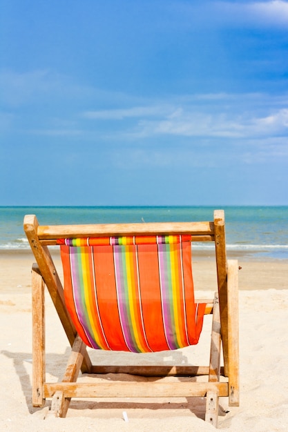 An empty wooden beach chair at the beach