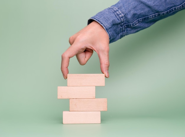 Empty wooden block with business hand