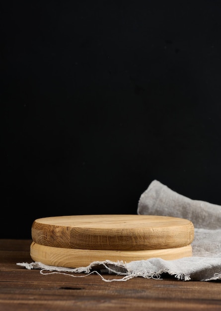 Empty wooden cutting board on brown table food display template