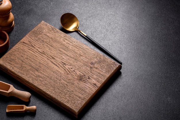 An empty wooden cutting board with wooden cutlery