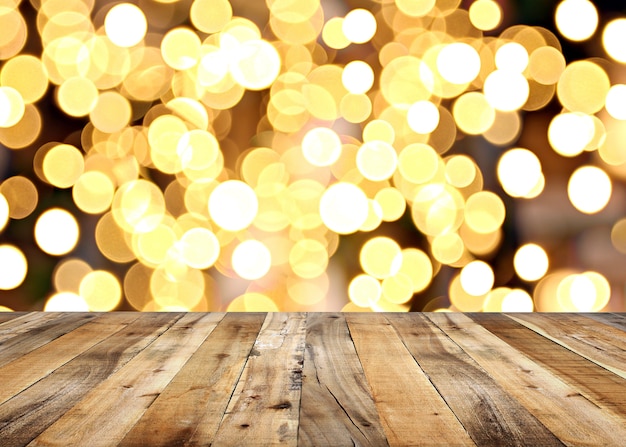 Empty wooden floor of plank table and bokeh lights of christmas background.