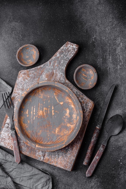 Empty wooden plate knife fork and cutting board