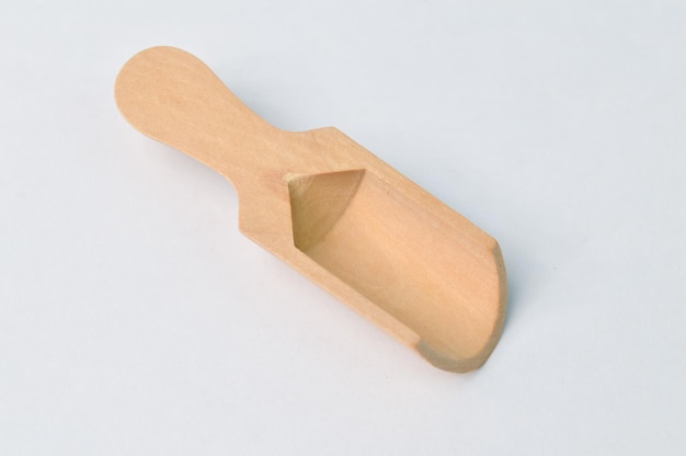 Empty wooden scoop isolated on a white background