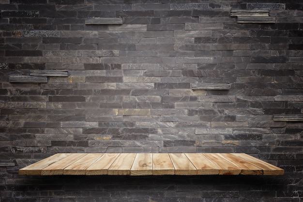 Empty wooden shelves and stone wall background. For product display 