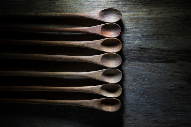 Empty wooden spoons on wood