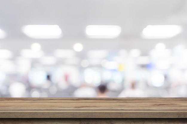 Empty wooden table anb Abstract blur airport interior for backgounrd